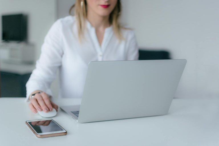 woman using silver laptop